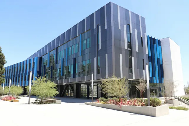 Modern commercial building with dark cladding and glass
