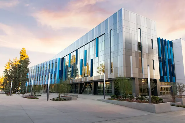 Modern low-rise office building with blue and silver cladding