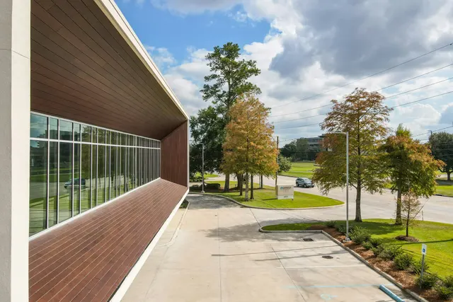 Low-rise office with a covered walkway and trees